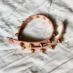 Pink leather brushed gold spike wrap bracelet, with 2 adjustable snaps.